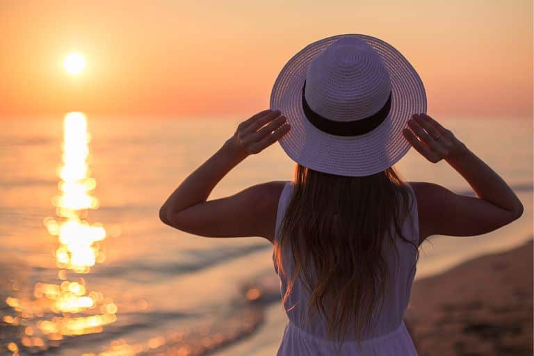 woman in a hat at sunset